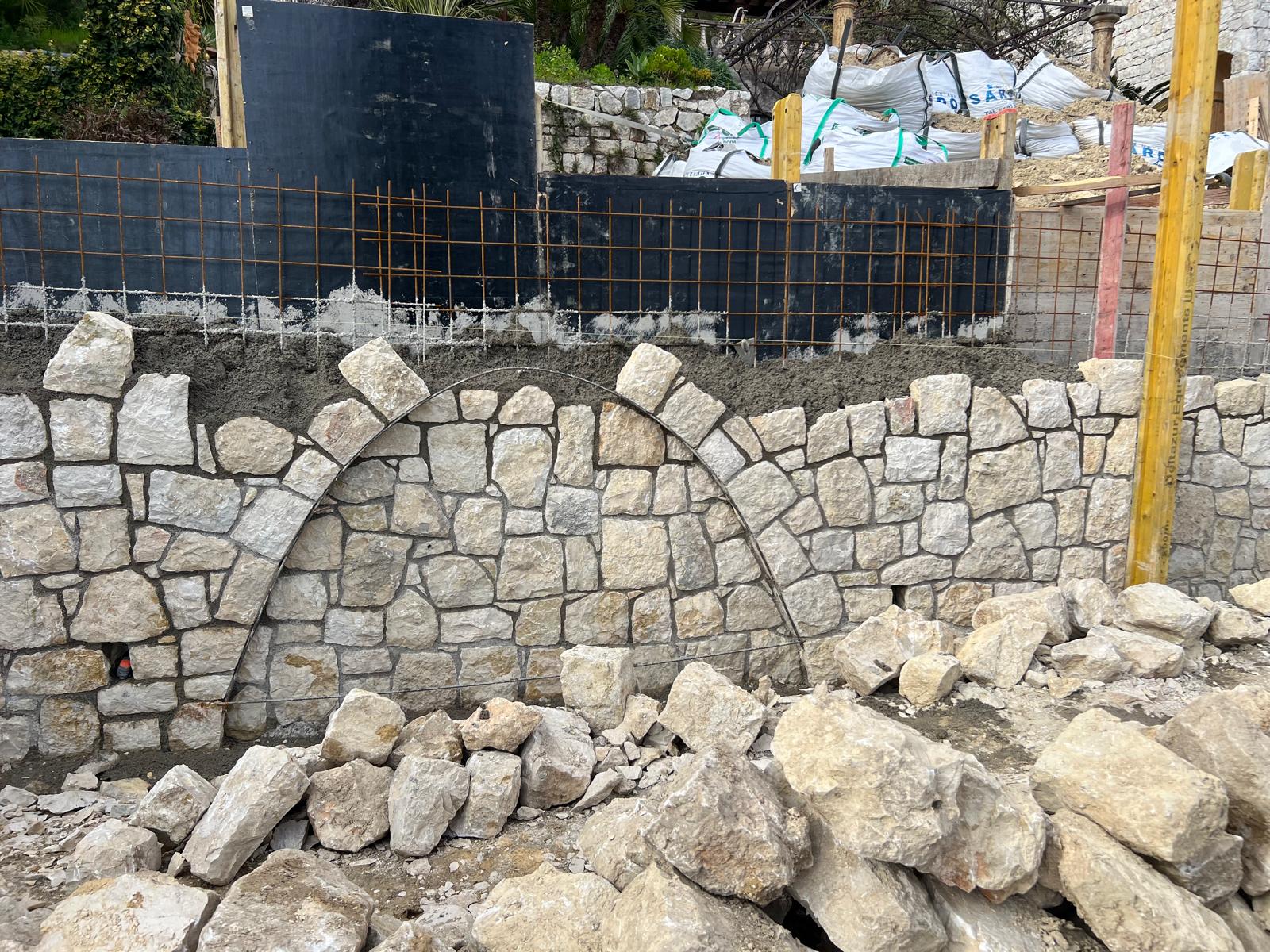 Détail rapproché du mur en pierre avec arches sculptées en cours